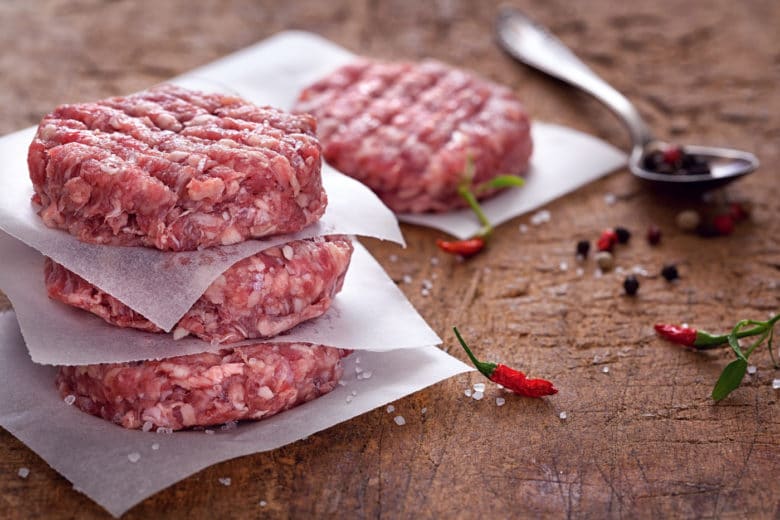 Frische Burger Patties in der Zubereitung